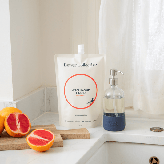 Grapefruit washing up liquid in kitchen with reusable dispenser and grapefruits.